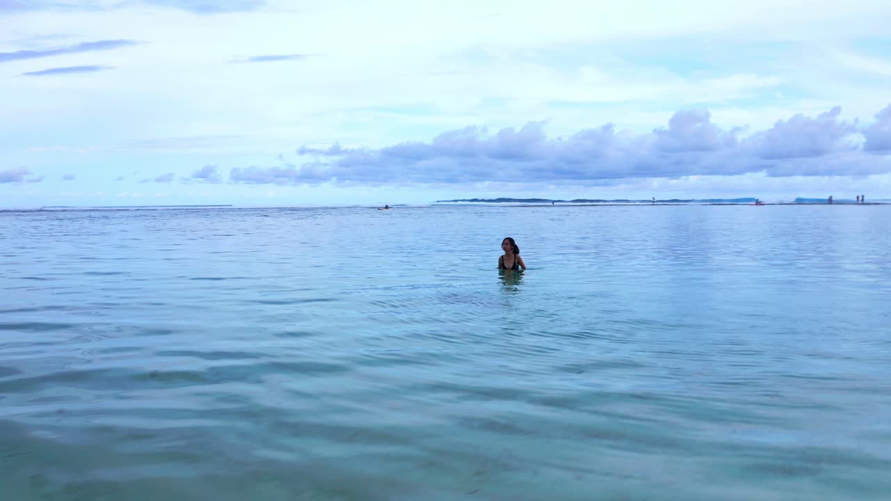 A Woman In A Crystal Clear Water Of Gunung Payung Beach In Bali Indonesia