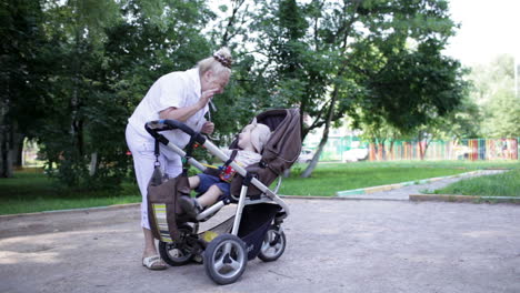 granny playing with her grandson in the yard