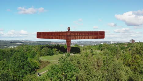 drone flying over trees towards the angel of the north at gateshead near newcastle england