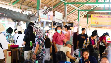 crowds explore vibrant market stalls in bangkok