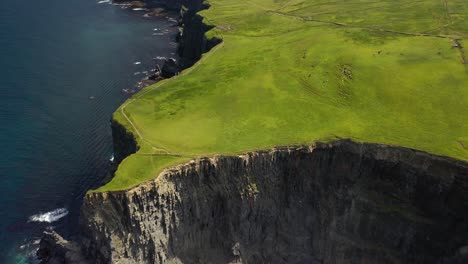 Green-Cliffs-of-Moher-tourist-attraction,-Ireland-west-coast,-aerial-reveal