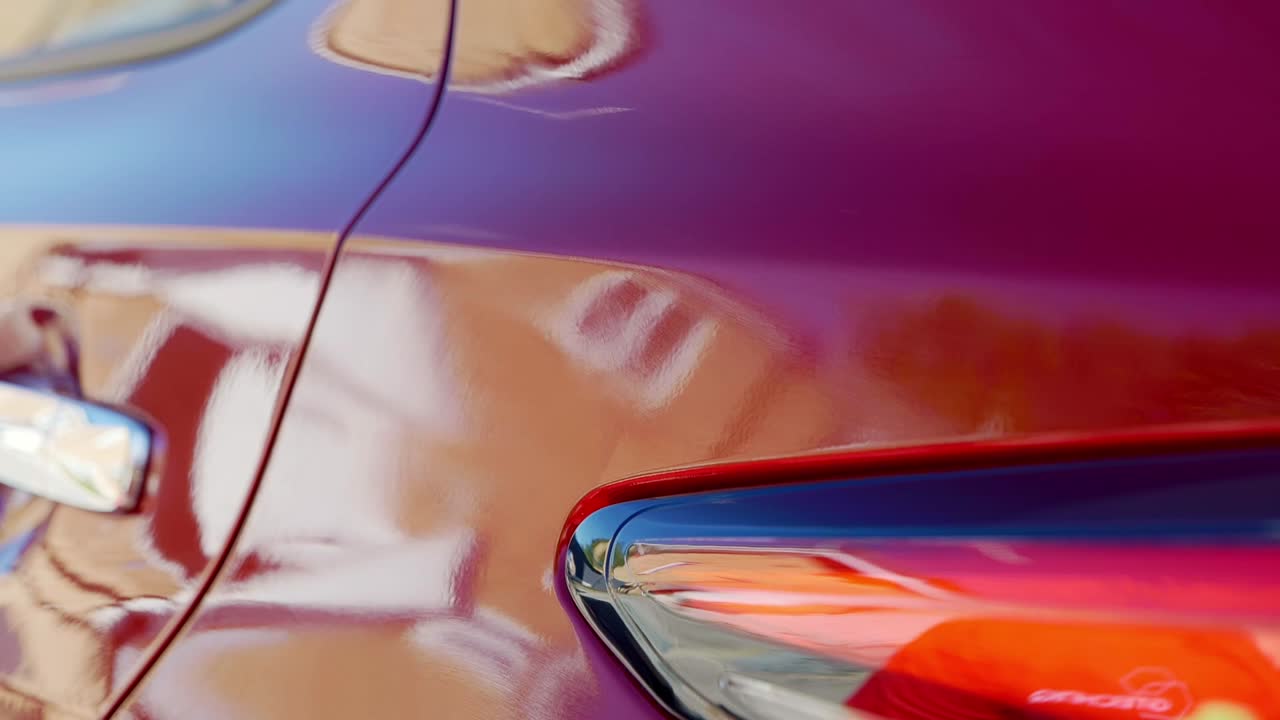 Removing ceramic coating from cherry red car outdoors