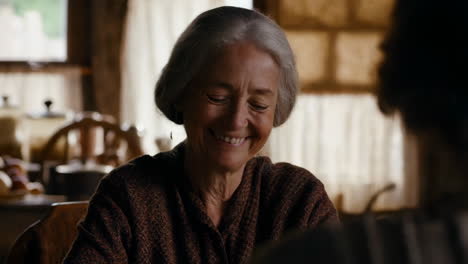 elderly woman smiling in a kitchen