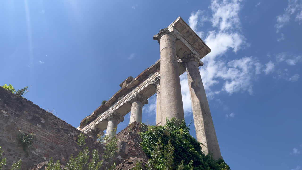 Crumbling marble columns from ancient Roman ruins in the Roman Forum, located in the heart of Rome. Perfect for history documentaries, travel videos, educational content, or ancient Rome projects