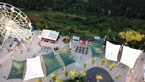 ferris wheel on the green hill kok tobe at sunset