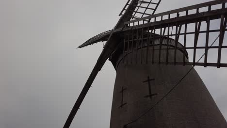 Bidston-hill-vintage-countryside-windmill-flour-mill-English-landmark-low-angle-dolly-left-looking-up