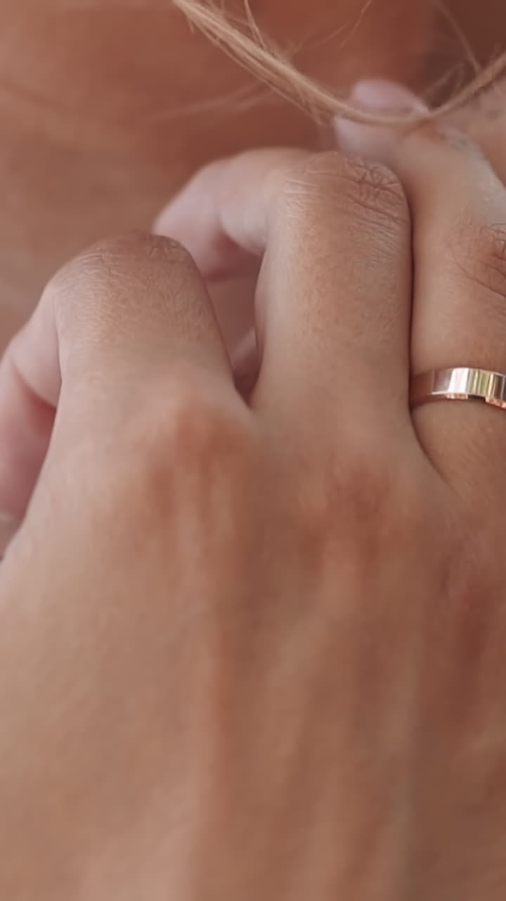 Bridegroom with freckles on arms and hands embraces newlywed wife in white dress at wedding ceremony closeup slow motion. Young couple in love relationship