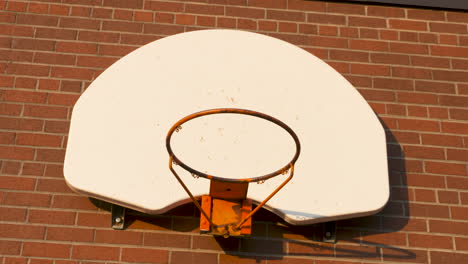 basketball net on a red brick wall