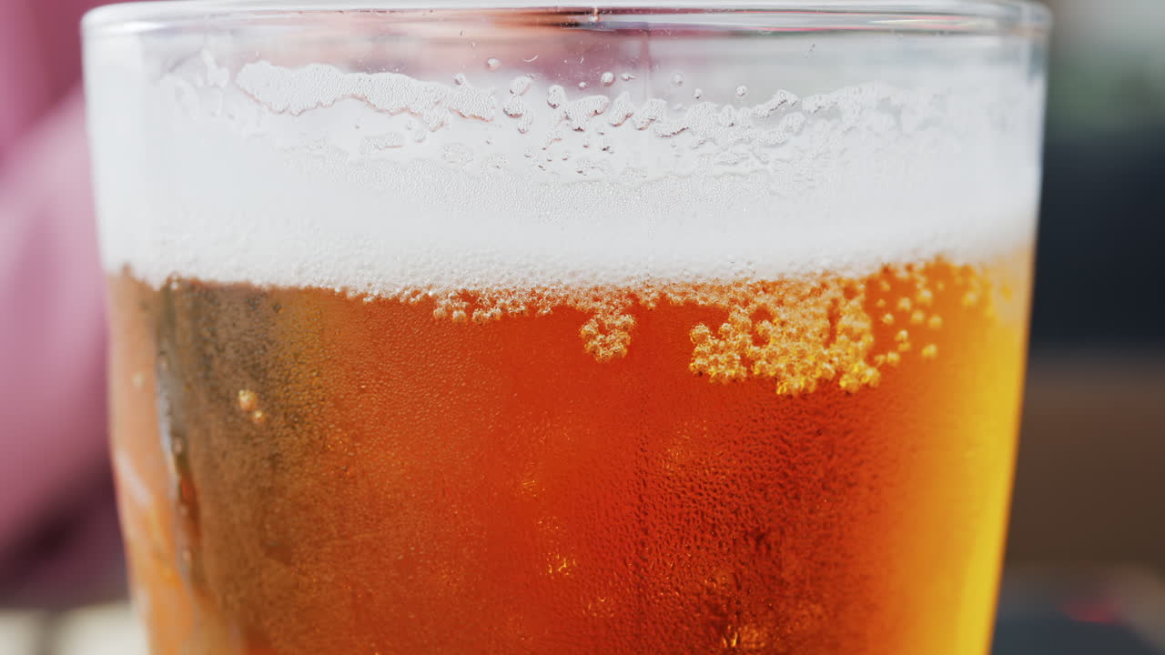 Close up of bubbles forming into foam in a beer glass