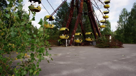 ferris wheel with yellow baskets in pripyat, close up tilting up view