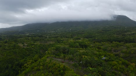 Aerial-Drone-Rises-Up-wet-stormy-skyline-in-Philippines-Mountains,-Jungle-Tropical-Green-Trees-and-Greenery-Landscape,-establishing