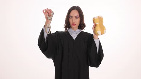 Woman in Judge Gown Holding Handcuffs and Gavel