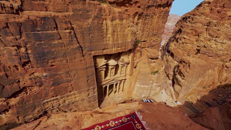 Famous-historic-UNESCO-heritage-site-Khaznet,-the-Treasury-carved-into-sandstone-at-Petra,-Jordan-seen-from-a-viewpoint-above