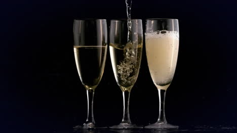 animation of champagne pouring into three glasses on black background