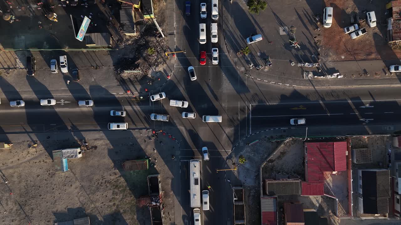 Aerial shot of a busy road with many vehicles in a lower income community