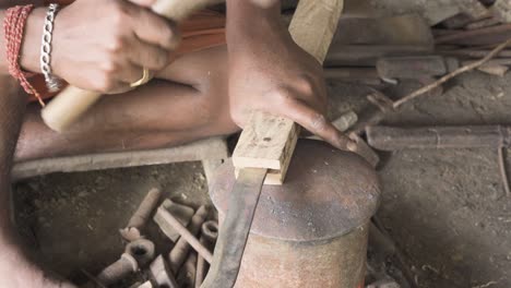 hammering nail into koduval cocunut knife