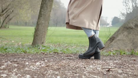 woman walking in the main avenue of querini park in vicenza, italy.