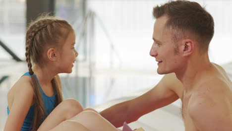 father and daughter at indoor pool