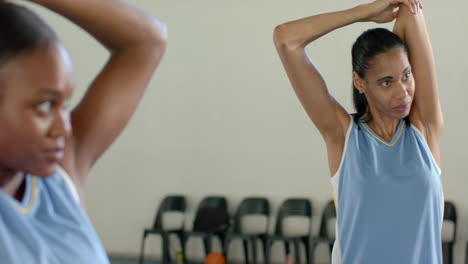 stretching before practice, female basketball player preparing for school game