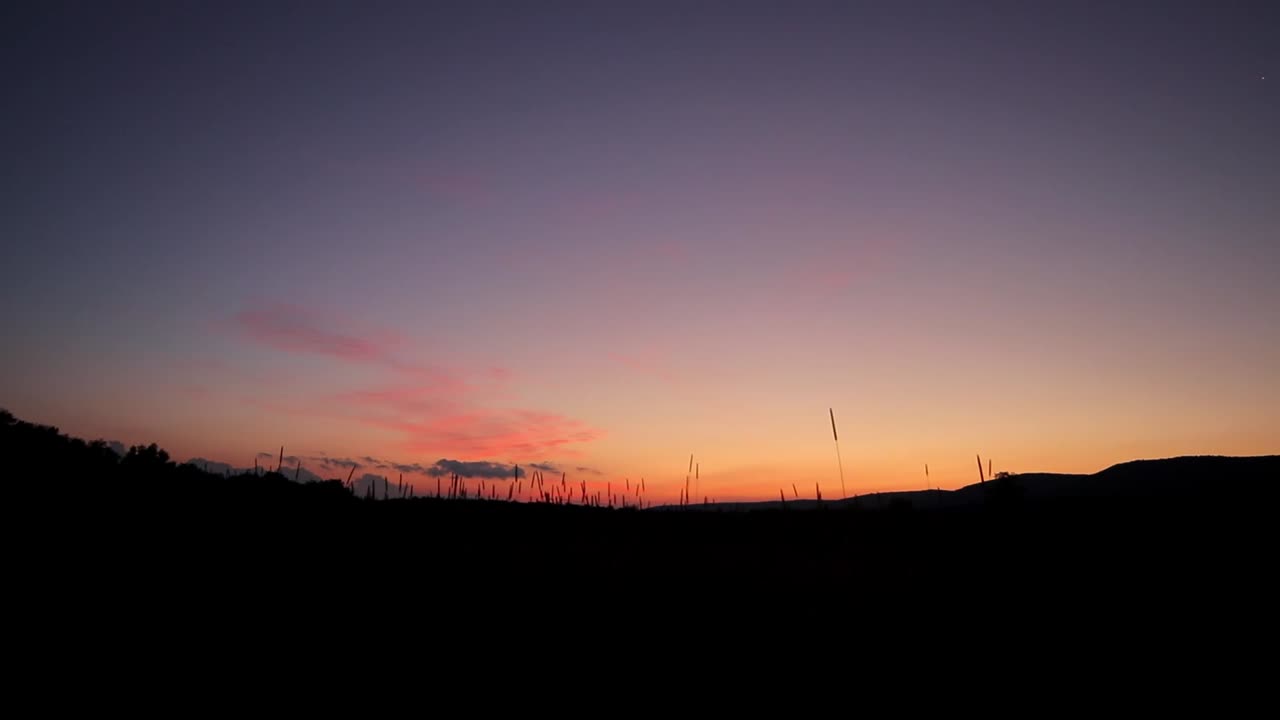 Pink Sunrise Clouds In Mountain Valley With Grass In Foreground Slider Shot Cinematic HD