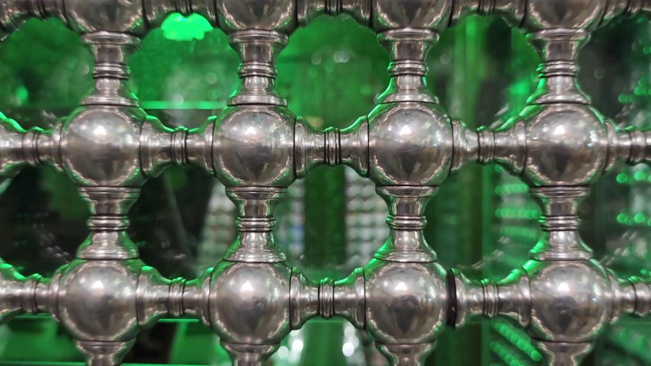Intricate Metal Grille Inside a Green Lit Shrine