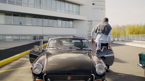 couple in a vintage convertible car