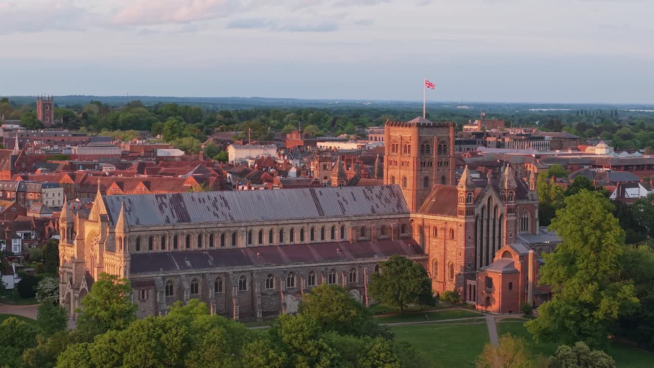A cinematic drone orbits St Albans Cathedral in the UK, capturing its majestic gothic architecture and historic grandeur from every angle in a breathtaking aerial view