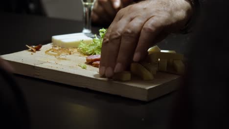 Slow-Motion-Close-Up-of-Hand-Picking-Cheese-in-High-End-Restaurant