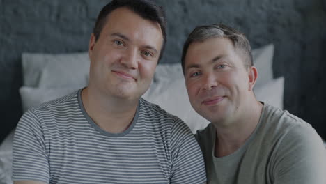 happy gay couple in bedroom