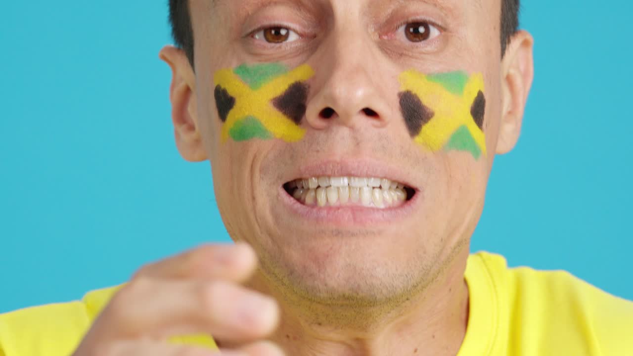 Very nervous man supporting jamaican team during a difficult match