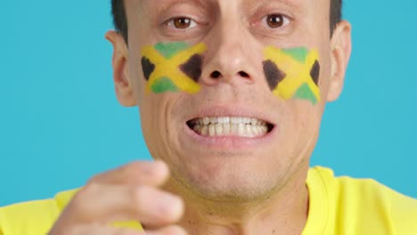 very nervous man supporting jamaican team during a difficult match