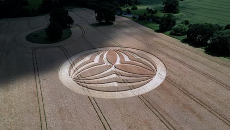 aerial view orbiting partially cloud shaded warminster rural farmland crop circle design