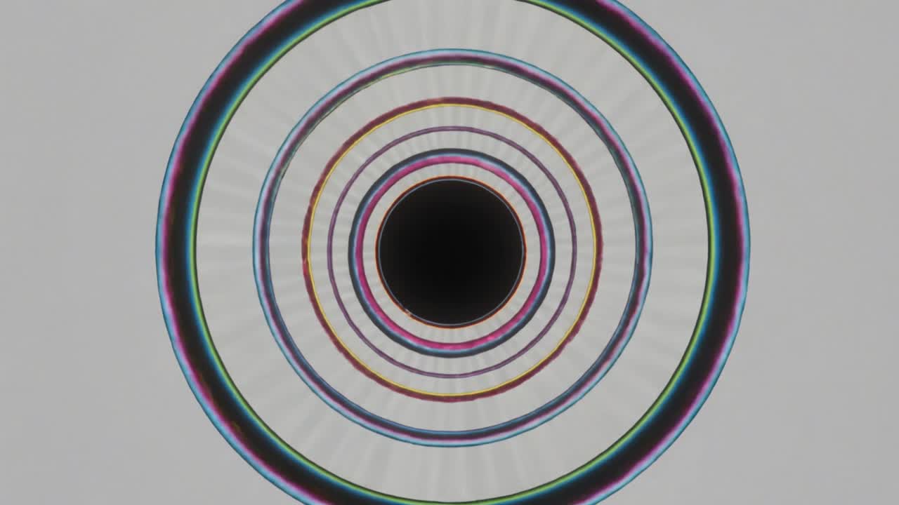 Concentric rings shifting hues and width on gray backdrop on play causing radial banding for design