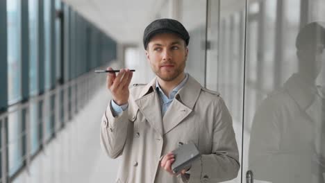 solid adult man talking on the phone while standing in the hallway