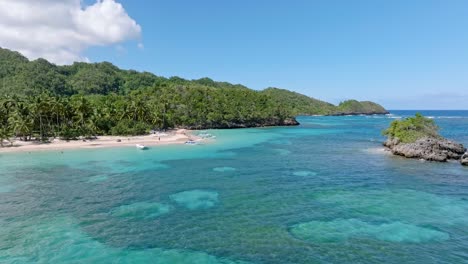 aerial over clear exotic caribbean waters with shallow reef, playa ermitano