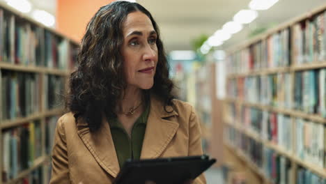 woman with tablet in library