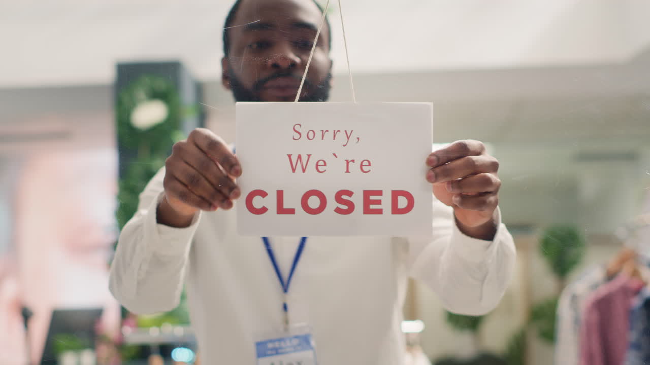 Retail clerk closing clothing store