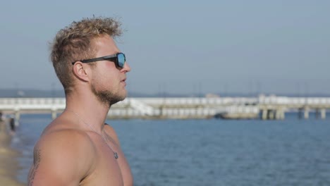 pensive young man looks out over the ocean