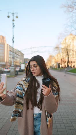 woman taking selfie on a city street