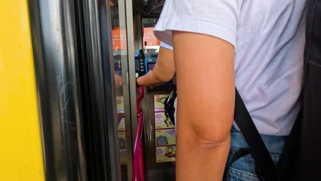 passengers entering a bus at a station