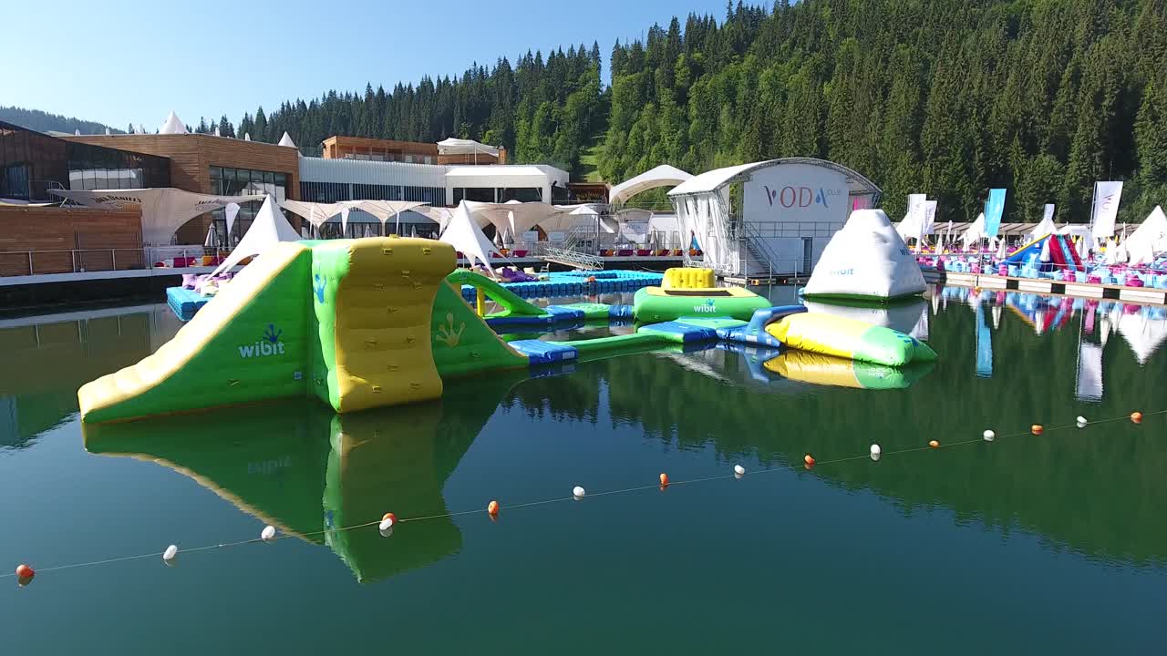 Bukovel, Ukraine - August 2017: Guest house in a mountain resort in summer. Swimming pool of luxury hotel. Aerial view