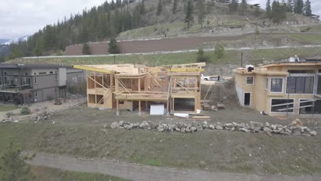 An-aerial-Drone-shot-of-a-house-overlooking-a-lake-being-constructed