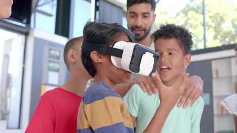 biracial boys explore virtual reality at school in the classroom