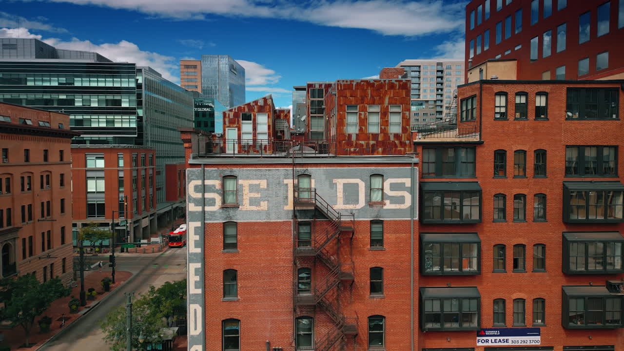 Denver, USA, 24 August 2025: Rising along the red-brick multi-storied building with outside fire escape stairs. Old-style buildings of Denver, Colorado, USA