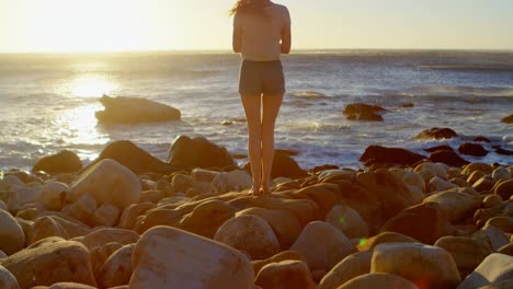 woman jumping against sunset 4k