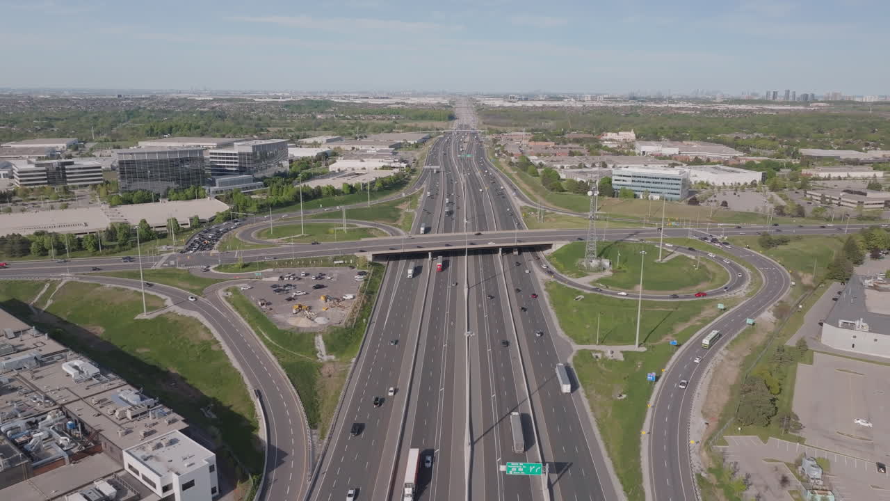 Wide aerial view of Highway 401 in Mississauga, showing traffic flow and surrounding area