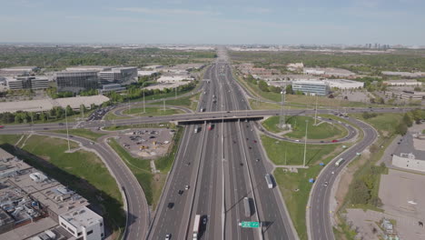 wide aerial view of highway 401 in mississauga, showing traffic flow and surrounding area