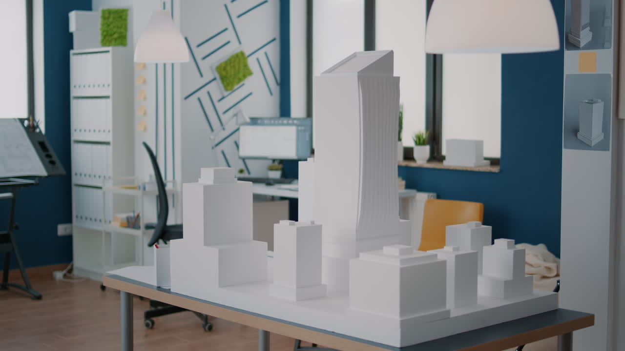 Concept of building model and construction design on table in empty workplace