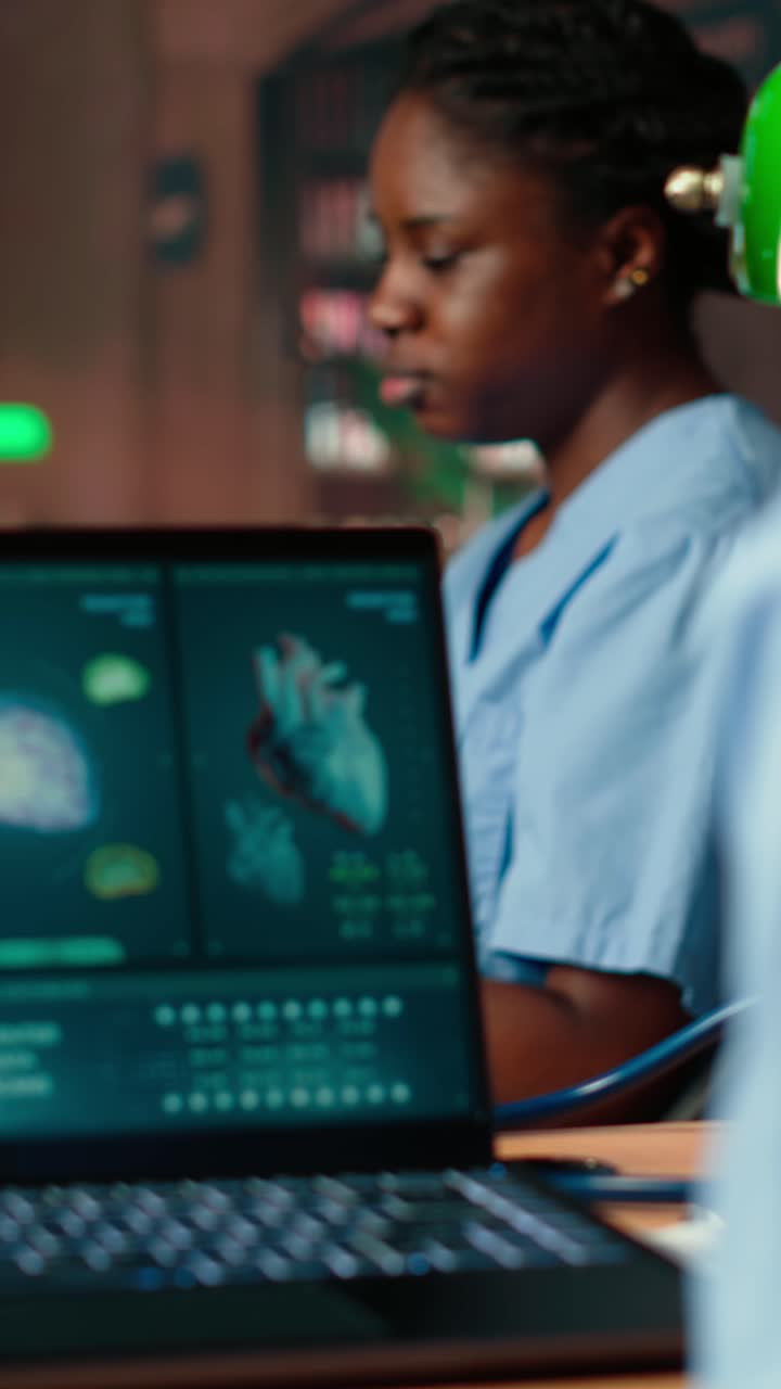 Medical Professional Analyzing Human Anatomy Data on Laptop