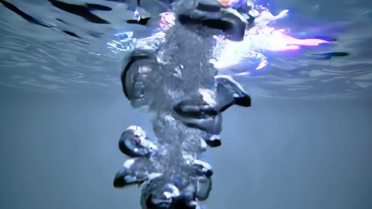 Underwater video shot from below captures bubbles rising to the surface, creating a serene